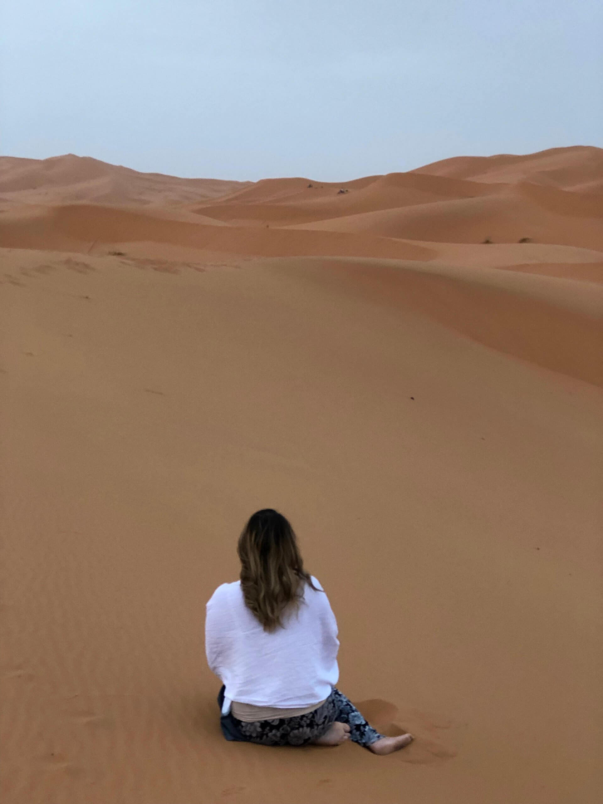 sitting in a desert merzouga tour